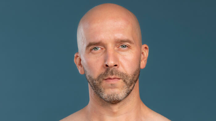Portrait of a sad bald man
