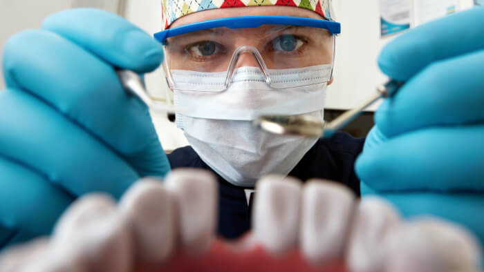 Dentist examining dental implant patient